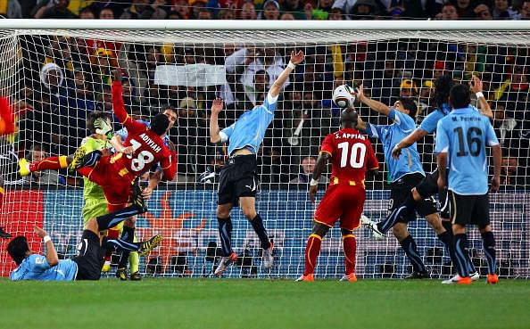 Luis Suarez of Uruguay handles the ball on the goal line, for which he is sent off, during the 2010 FIFA World Cup South Africa Quarter Final match between Uruguay and Ghana at the Soccer City stadium on July 2, 2010 in Johannesburg, South Africa.  (Photo by Michael Steele/Getty Images)